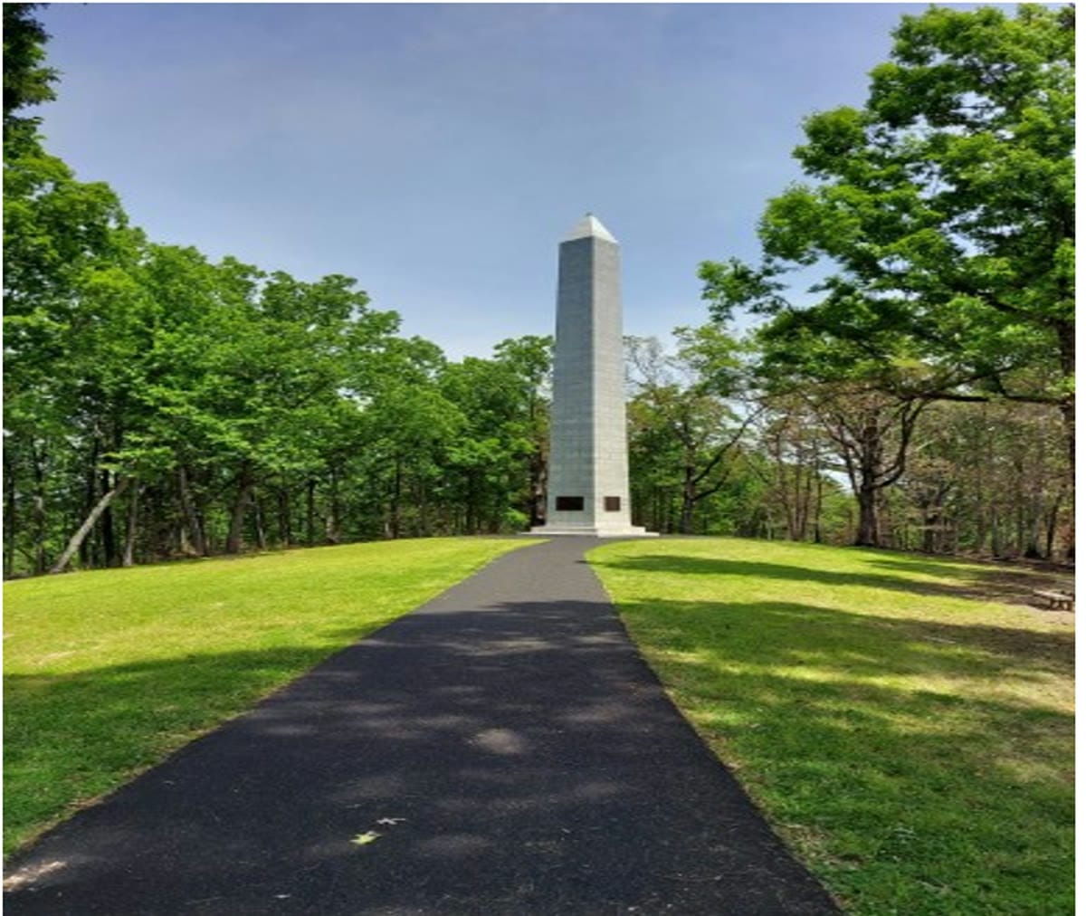 The monument to the men of the Battle of Kings Mountain, a tall stone obelisk at the end of a paved path